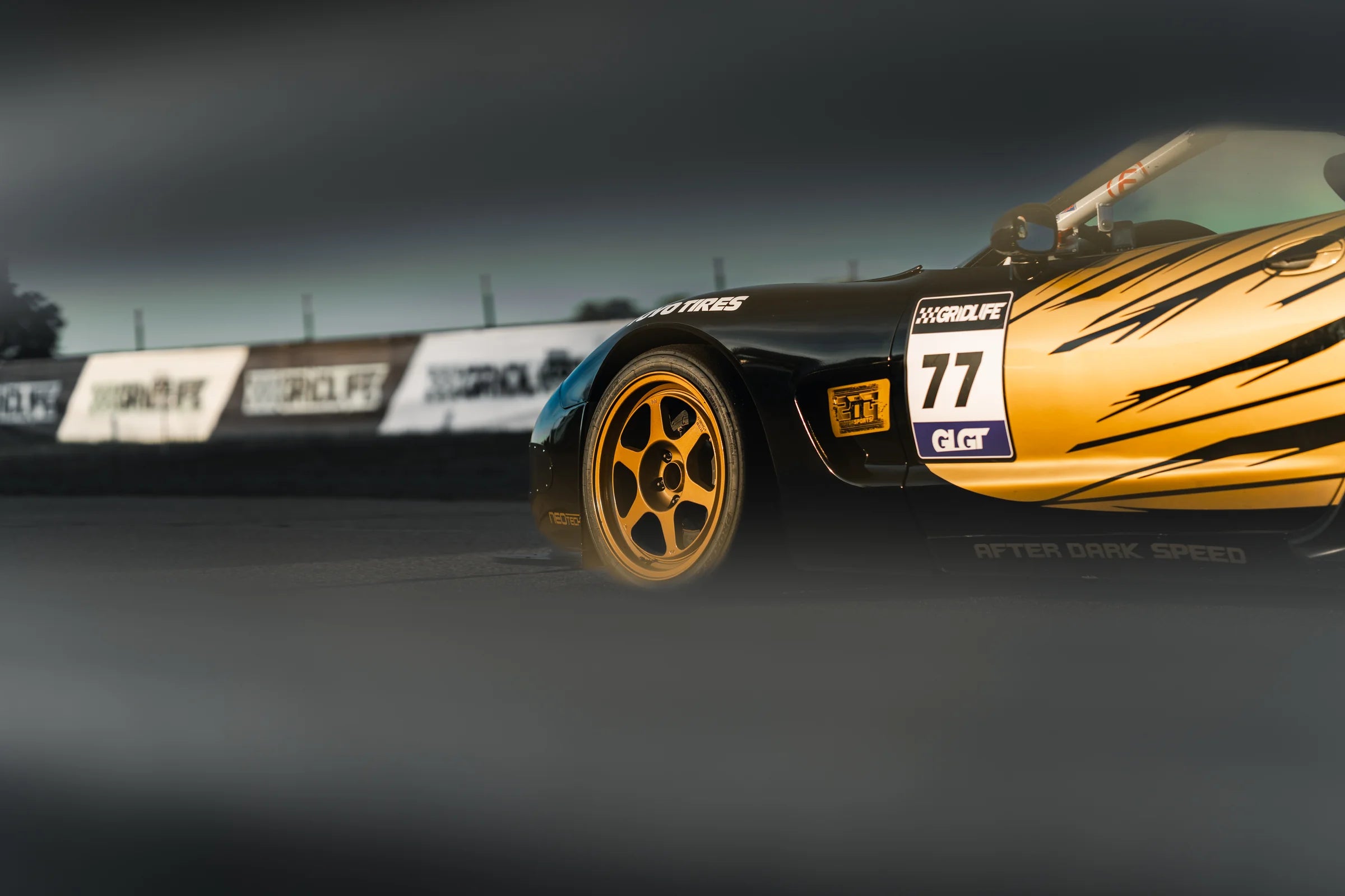 Black and gold number 77 Corvette with six-spoke wheels at Gridlife